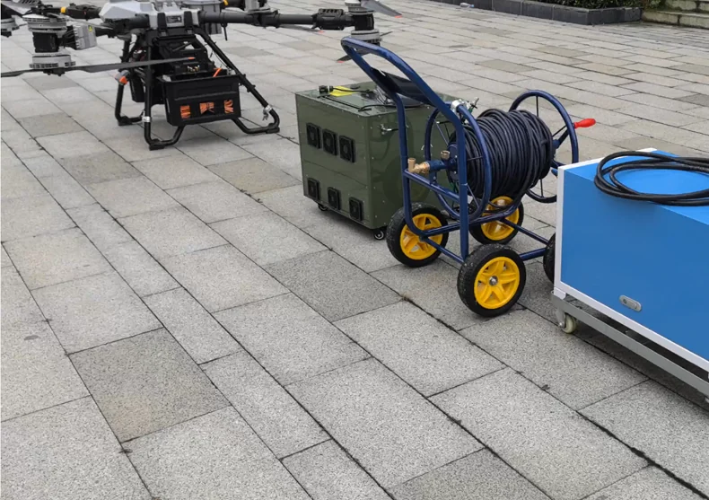 DJI FC100 tethered facade-cleaning reference system with ground power, cable management, and a high-pressure pump